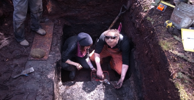 Alisha Gauvreau, left, and Dr. Duncan McLaren, right, collect a sediment sample below a stone artifact discovered in the site. 