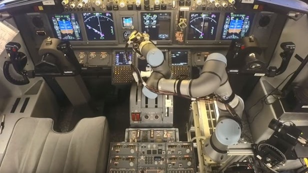 The ALIAS system operating the 737 controls using a robotic arm