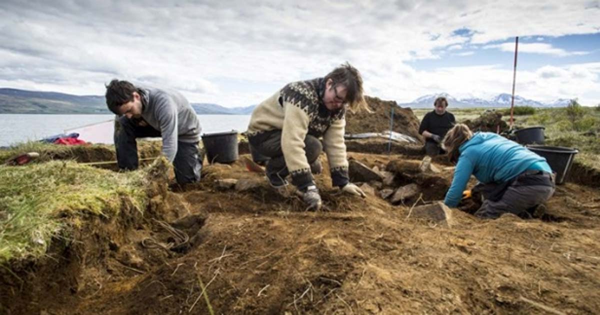 Archaeologists dig at the site of the first ship burial, where the human and dog bones, the ship and sword were found. You can see how close the waters of the fjord are in the background. 