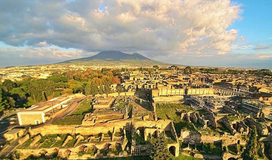 Ruins of Pompeii seen from the above with a drone, with the Vesuvius in the background 