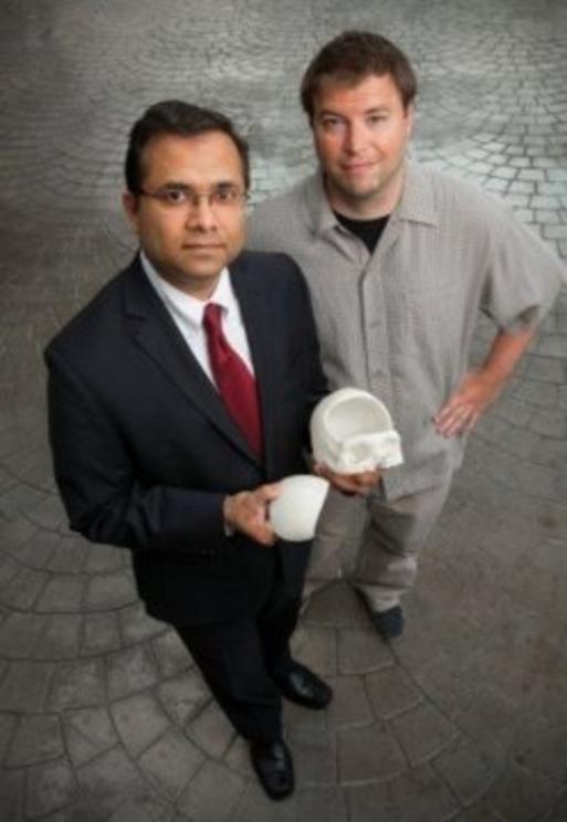 Gaurav Gupta, MD, assistant professor of neurosurgery at Rutgers Robert Wood Johnson Medical School (left) with patient Chris Cahill who received a 3-D printed skull. Credit: John Emerson