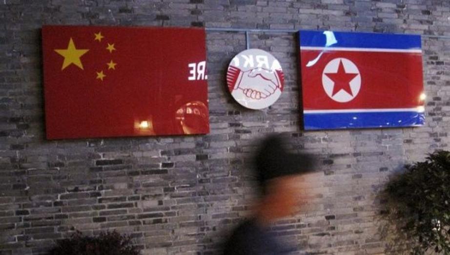 The flags of China and the Democratic People's Republic of Korea, also known as North Korea, in a Chinese Restaurant. | Photo: REUTERS
