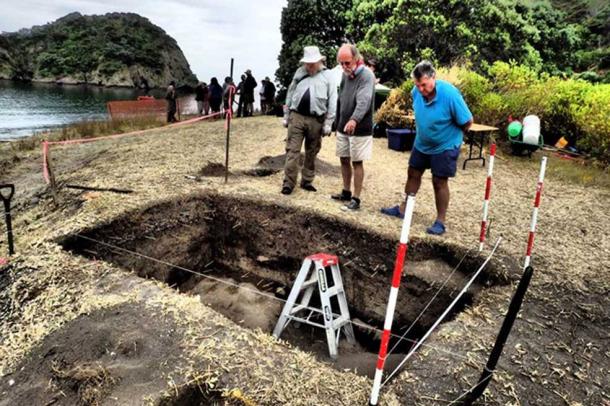 Archaeologists John Coster and Dave Veart, along with local volunteer Jack Kemp, examine the re-opened excavation unit from 1981. 