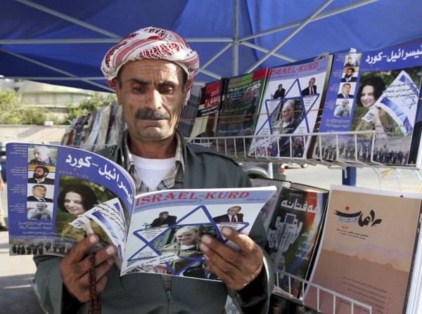 An Iraqi Kurd reads a copy of the magazine Israel-Kurd on a street in Irbil, Iraq in 2009. (Azad Lashkari/Reuters)