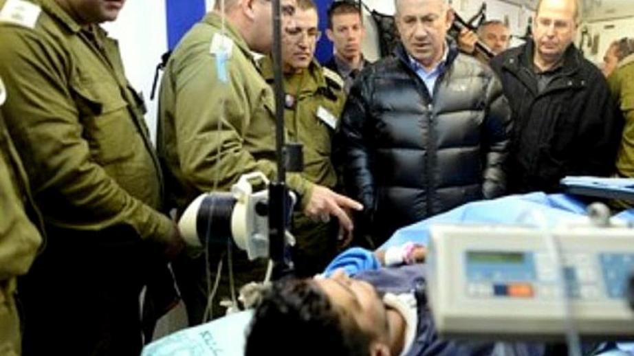 Israel Prime Minister Benjamin Netanyahu looks on as a Syrian rebel fighter is treated in an IDF field hospital. (Photo: Kobi Gideon/GPO)