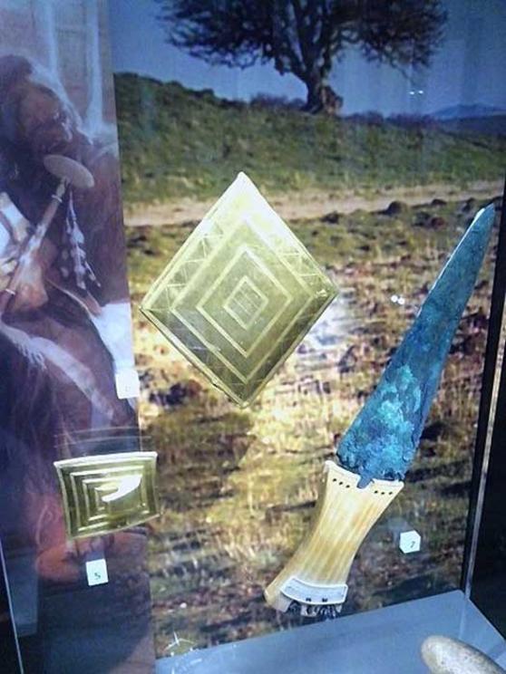 Gold lozenge, gold belt buckle, copper dagger. Bronze Age grave goods from Wilsford G5, Bush Barrow. 