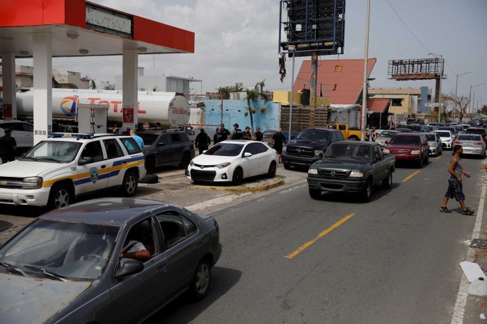 People queue to buy gasoline at a gas station after the area was hit by Hurricane Maria in Carolina, Puerto Rico September 26, 2017. 