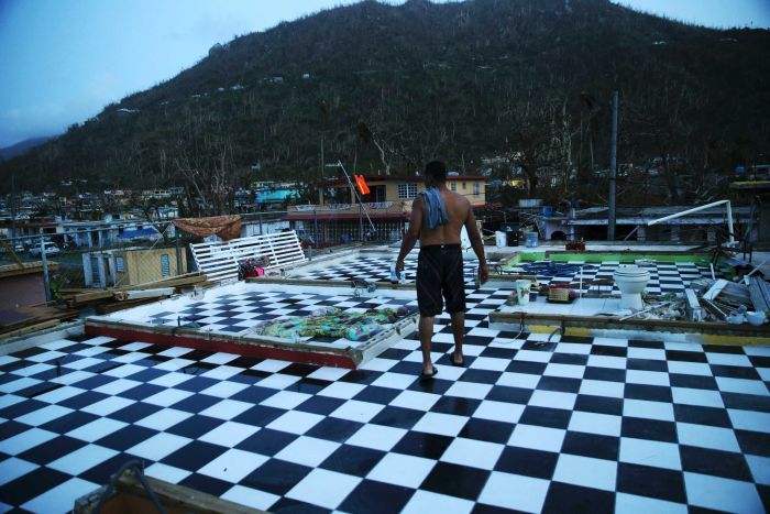 Nestor Serrano walks on the upstairs floor of his home, where the walls were blown off, in the aftermath of Hurricane Maria, in Yabucoa, Puerto Rico, Tuesday, Sept. 26, 2017. 