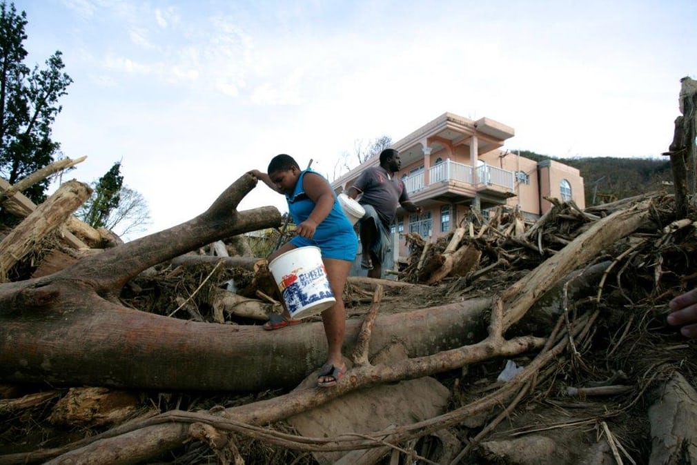  A father and son search for clean water in Castle Comfort, a small community in the parish of St George. The island’s lush vegetation has been left scarred by the hurricane, with thousands of trees snapped and strewn across the now partially barren lands