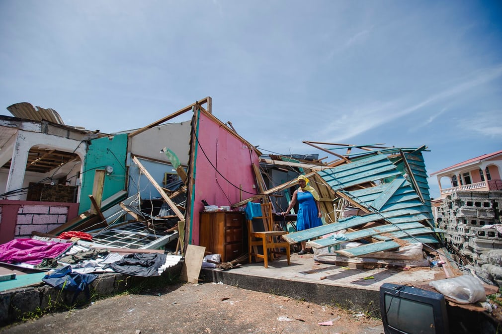  A woman stands amid the ruins of her home in Roseau. Almost every building on the island was damaged or destroyed  Photograph: Lionel Chamoiseau/AFP/Getty Images