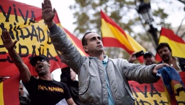 Demonstrators seen giving fascist salutes at a rally against Catalan independence. | Photo: AFP