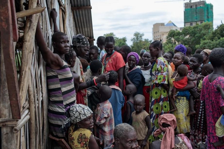 Women and children arrive for a distribution of clothing at St Mary’s cemetery. 