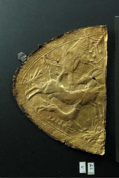 Embossed gold application with motif of animal combat of Levantine origin.