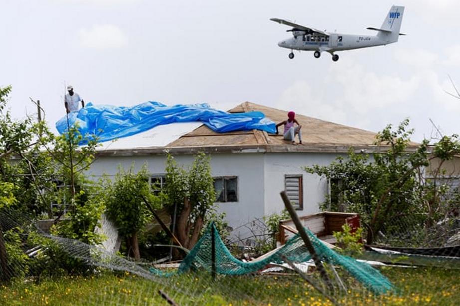 Devon Warner and his daughter Che Niesha work on the roof of a home in Codrington, Barbuda. 