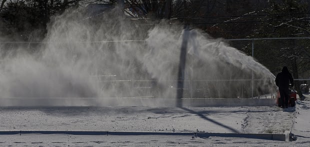 A town recreational employee clears snow from an outdoor skating rink in Burlington, Massachusetts, on Tuesday. Photograph: Cj Gunther/EPA