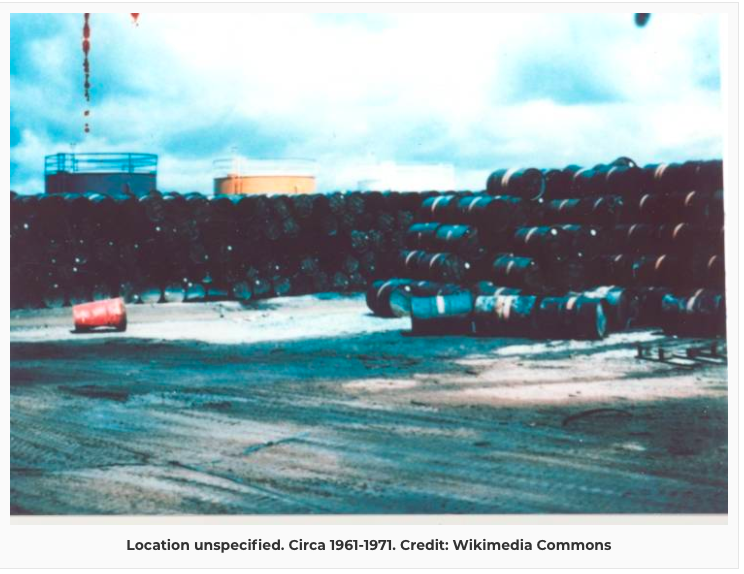 A massive stack of 55-gallon drums full of Agent Orange waits to be poured over the people of Vietnam.