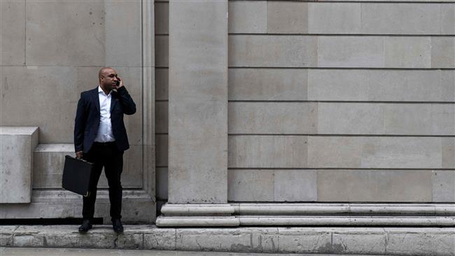 A businessman stands and speaks on his mobile phone outside the Bank of England in London on March 29, 2017.