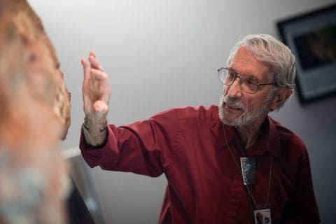 Ray Stanford explains the various types of fossil footprint on the 10-foot-long slab from Goddard.