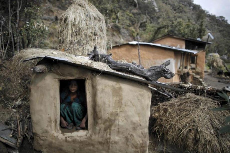 Uttara Saud, 14, sits inside a Chhaupadi shed where Nepalese women are banished to while menstruating.