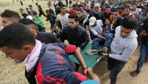 A wounded Palestinian is evacuated during clashes with Israeli troops, during a tent city protest along the Israel border with Gaza, demanding the right to return to their homeland, the southern Gaza Strip March 30, 2018. | Photo: Reuters