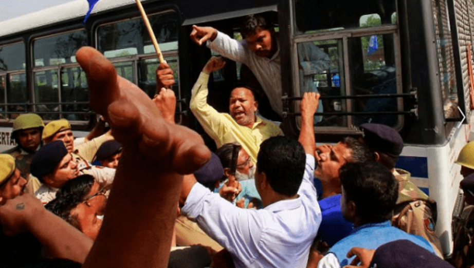 People belonging to the Dalit community shout slogans as they are detained by the police during a protest following a nationwide strike called by Dalit organizations. | Photo: Reuters 