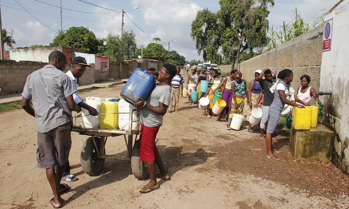 People line up to collect water from Pragosa, a Portuguese construction firm, in Maputo, Mozambique. 