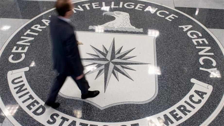 A man crosses the Central Intelligence Agency (CIA) logo in the lobby of CIA Headquarters in Langley, Virginia, on August 14, 2008. (Photo by AFP)