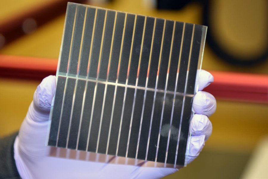 Perovskite solar cells have not yet been produced on a commercial scale. Currently, the OIST Energy Materials and Surface Sciences Unit's new perovskite solar cells are small enough for Dr. Liu to hold them in the palm of his hand.  Credit: OIST; Creative