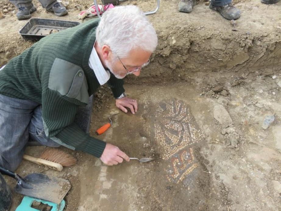 A Boxford volunteer begins to uncover the mosaic. 